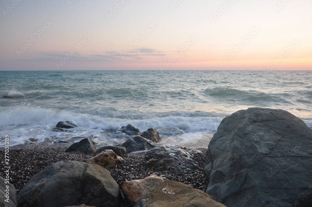 sunset on coast of sea