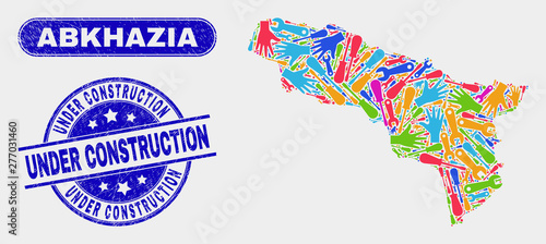 Production Abkhazia map and blue Under Construction scratched seal. Colored vector Abkhazia map mosaic of productivity elements. Blue round Under Construction seal.