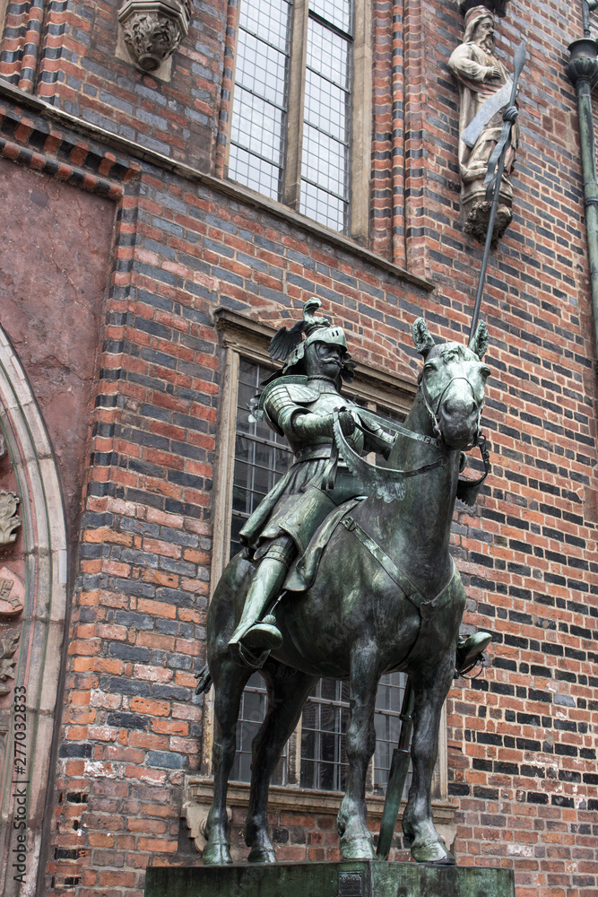 Bremen, Germany - 06/15/2019: bronze statue of medieval knights near Bremen town hall. Cultural heritage of Germany. Ancient sculptures in center of Bremen. Medieval art and architecture.