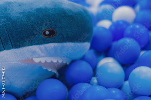 Colorful balls and shark stuffed animals.