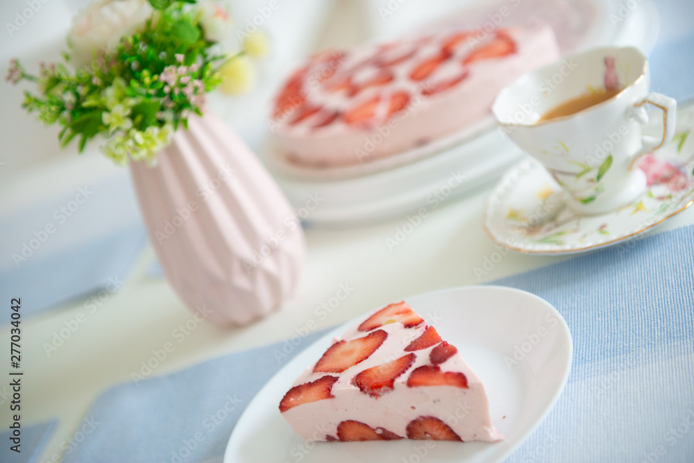Fresh cheesecake with strawberries on a table