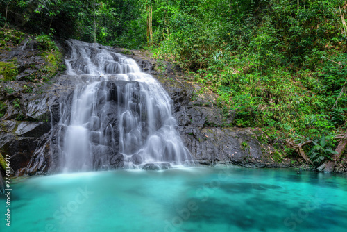 Fototapeta Naklejka Na Ścianę i Meble -  Tropical waterfall in the forest and mountain ,Ton Chong Fa in khao lak Phangnga South of Thailand. horizontal landscape, left.