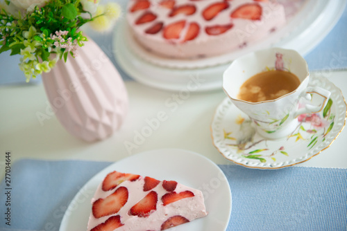 Fresh cheesecake with strawberries on a table