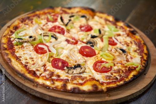 Delicious pizza with vegetables on the table