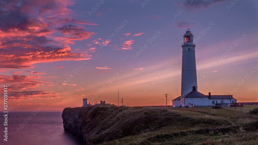 Nash Point Lighthouse at sunset. The lighthouse is in South Wales, on the Welsh Coastal Path. Nash Point Lighthouse at sunset. The lighthouse is in South Wales, on the Welsh Coastal Path.