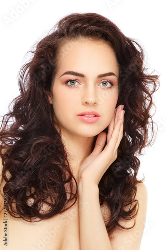 Portrait of young beautiful woman with long curly hair and fresh makeup