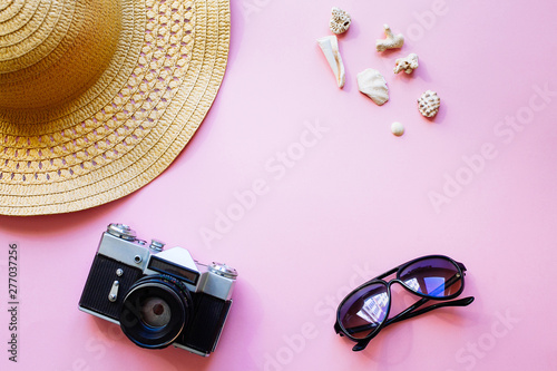 Flat lay design of travel concept with camera, hat, shells