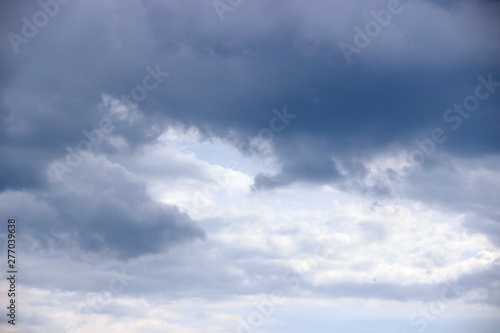 clouds in the spring sky, close-up. running in the sun clouds in the blue sky immediately after the rain