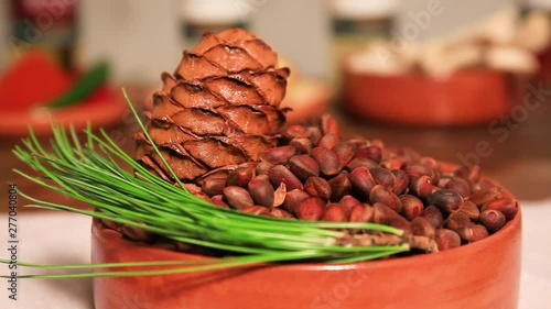 Cedar cone and grains lie in the bowl photo