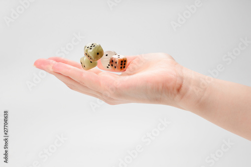 Woman throws dices isolated on white.