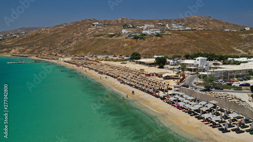 Fototapeta Naklejka Na Ścianę i Meble -  Aerial drone photo of famous organised beach of Elia with emerald clear sandy sea shore, Mykonos island, Cyclades, Greece  