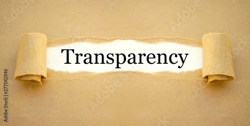 Paper work and magnifying glass with word transparency
