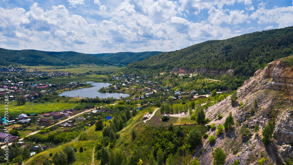  Aerial view from the drone of the village on the background among the hills. The middle band of Russia.