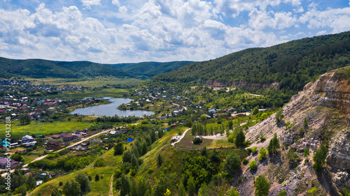  Aerial view from the drone of the village on the background among the hills. The middle band of Russia.