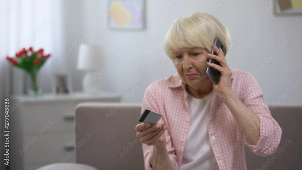 Confused aged woman with credit card calling bank support, payment problems Confused aged woman with credit card calling bank support, payment problems