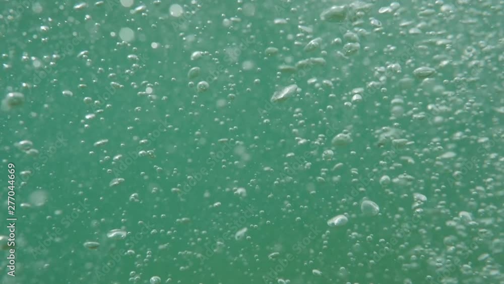 Bubbles rising to the surface. Slow motion. Air bubbles in clear blue water (underwater shot), good for backgrounds. Bubbles rising to the surface. Slow motion. Air bubbles in clear blue water (underwater shot), good for backgrounds.