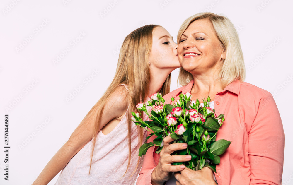 Surprise! I love my grandma. Family holidays and celebrations. Close up photo of happy grandmother and granddaughter in good and fun mood isolated together on white background.