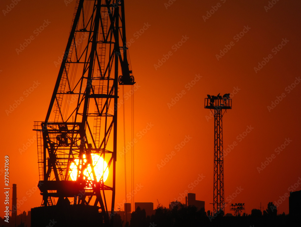 Construction cranes at sunset in the port of Odessa, Black Sea, Ukraine