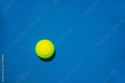 Tennis ball on blue background. Sport tennis layout. Flat lay, top view. © IrynaV