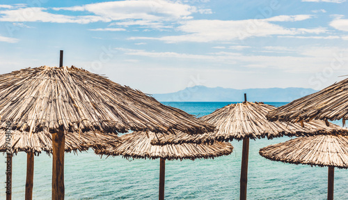 Straw umbrellas on tropical beach