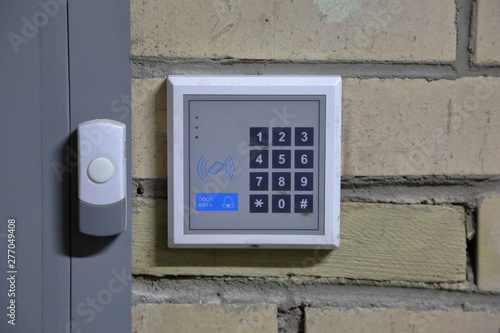 Modern electric door bell on the inner wall of the building