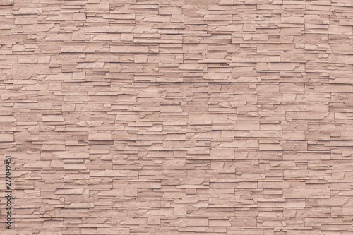 Rock stone brick tile wall aged texture detailed pattern background in cream red brown color