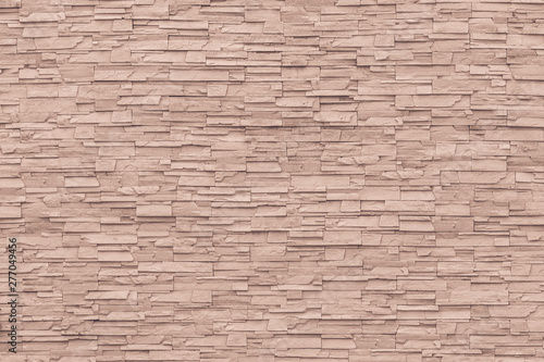 Rock stone brick tile wall aged texture detailed pattern background in cream red brown color