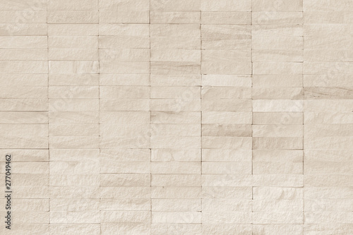 Rock stone tile wall texture rough patterned background in white cream color