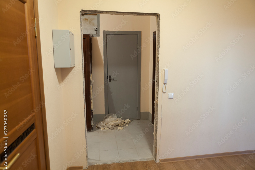 Empty aperture of door in wall of domestic hall, preparations for new door installing Empty aperture of door in wall of domestic hall, preparations for new door installing