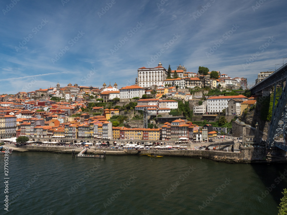 Portugal, June 2019: Porto Cityscape over Douro River and medieval Ribeira district, Portugal. One of the oldest European centres, its historical core was proclaimed a World Heritage Site by UNESCO.