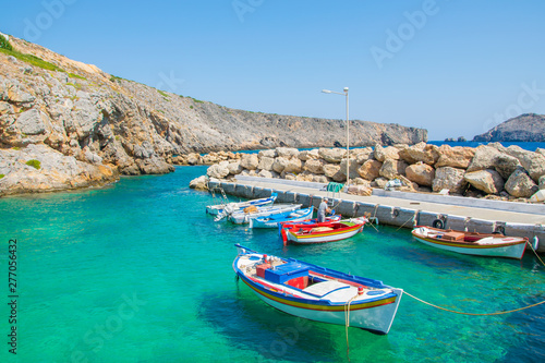 Little port with colorful fishing boats and turquoise sea waters in Potamos village in Antikythera island in Greece
