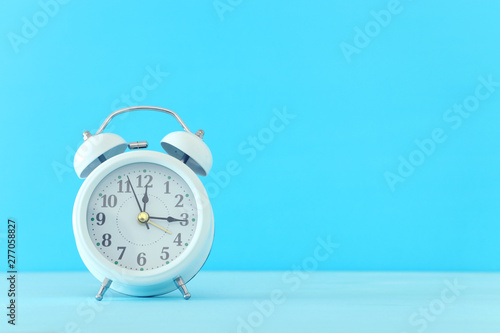 white retro clock over blue background