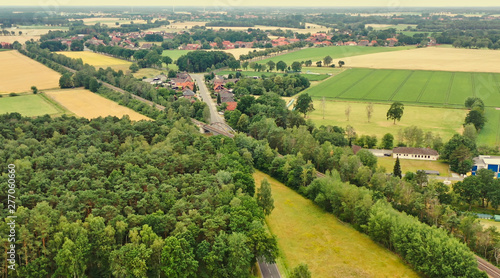 Aerial view of a small German village in the flat region of northern Germany with pastures, arable land and cows. © Frank
