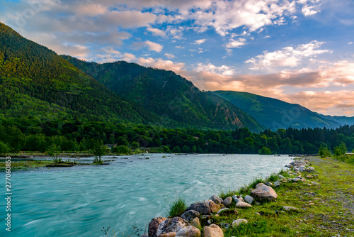 The river flows in a deep gorge, the mountains of Caucasus.