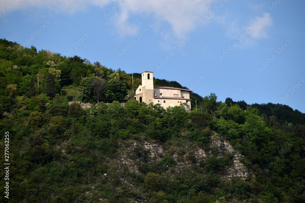 An ancient church among the vegetation on the slopes of a hill