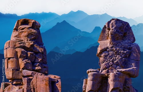 Colossi of Memnon Luxor Thebes against the background of dawn in the Egypt