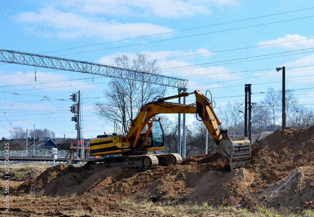 Excavator working on a construction site on the railway Excavator working on a construction site on the railway