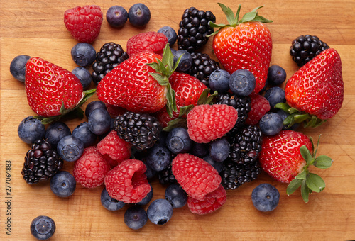 Various fresh summer berries. Ripe strawberries, blackberries, blueberries, raspberries. Top view. Background berries and fruits