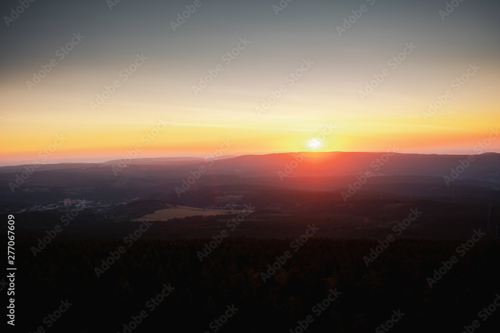 Mountain nature landscape panorama with silhouette layers and valley view at sunset colorful sky. Wolfswarte, Torfhaus, National Park Harz in Germany