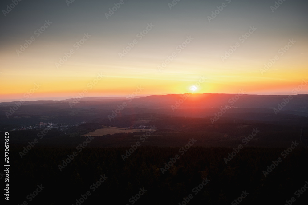 Mountain nature landscape panorama with silhouette layers and valley view at sunset colorful sky. Wolfswarte, Torfhaus, National Park Harz in Germany Mountain nature landscape panorama with silhouette layers and valley view at sunset colorful sky. Wolfswarte, Torfhaus, National Park Harz in Germany