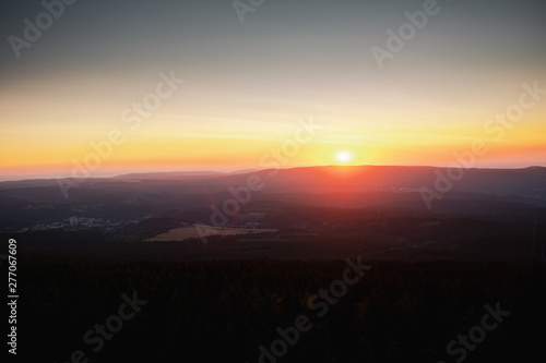 Mountain nature landscape panorama with silhouette layers and valley view at sunset colorful sky. Wolfswarte  Torfhaus  National Park Harz in Germany