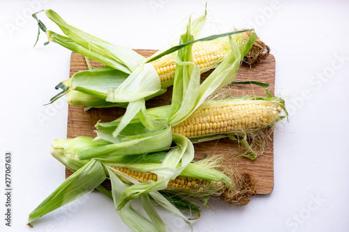 Fresh Corn on white table. ear of corn. Summer concept