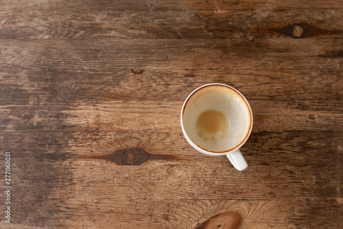 Closeup of Empty white coffee's cup after drink on wooden table