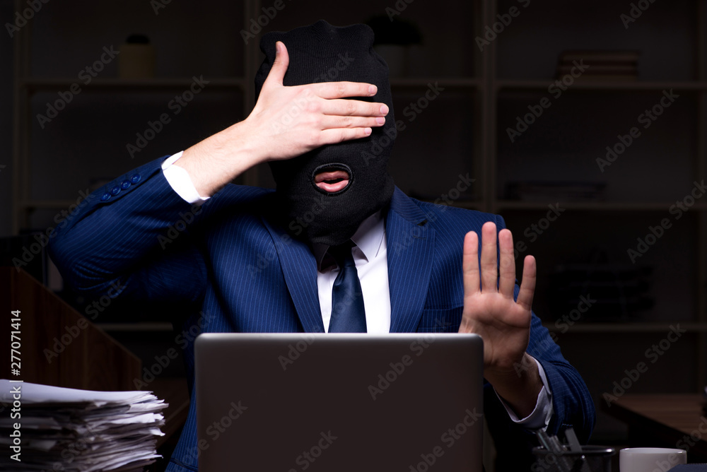 Male employee stealing information in the office night time Male employee stealing information in the office night time