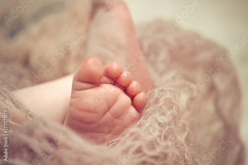 Foot of a newborn baby close up. Selective soft focus