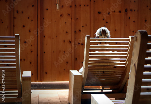 woman sitting in sauna chair