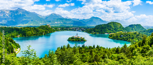 Beautiful landscape of Lake Bled the church island in the middle and the castle in the background of white clouded sky from Ojstrica viewpoint in Bled, Slovenia