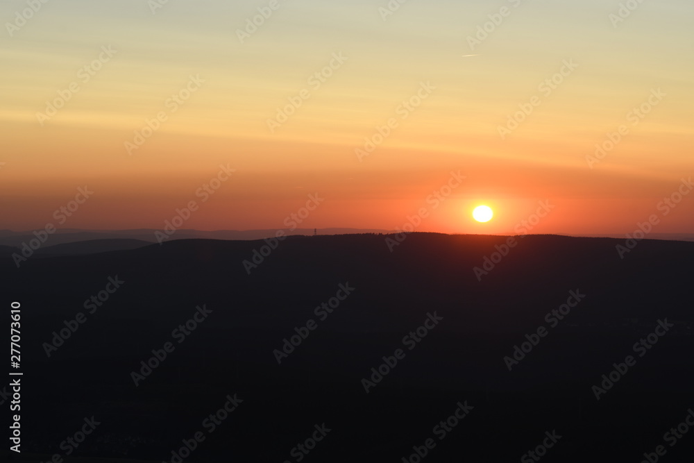 Mountain panorama view with mountain silhouettes an sunset color tones. Harz National Park, Wolfswarte