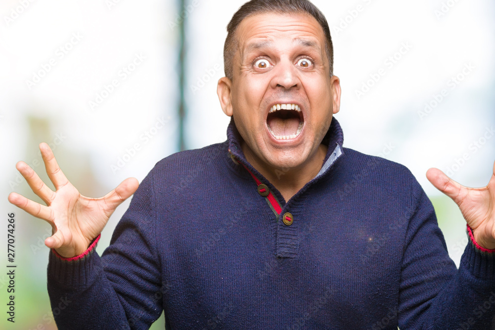 Middle age arab man over isolated background celebrating crazy and amazed for success with arms raised and open eyes screaming excited. Winner concept Middle age arab man over isolated background celebrating crazy and amazed for success with arms raised and open eyes screaming excited. Winner concept