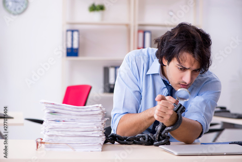 Young male businessman employee unhappy with excessive work  